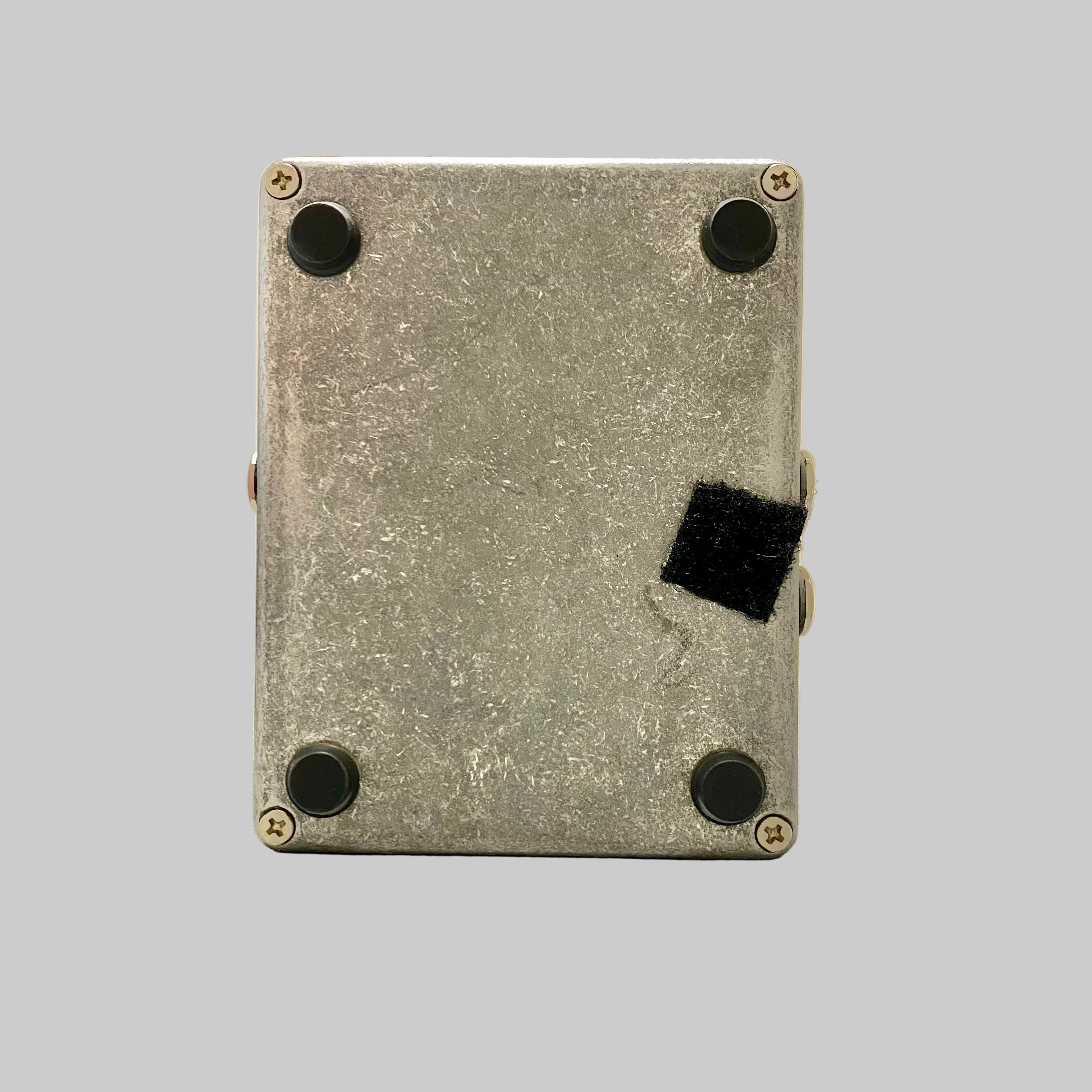 Metal box with black patches on a surface