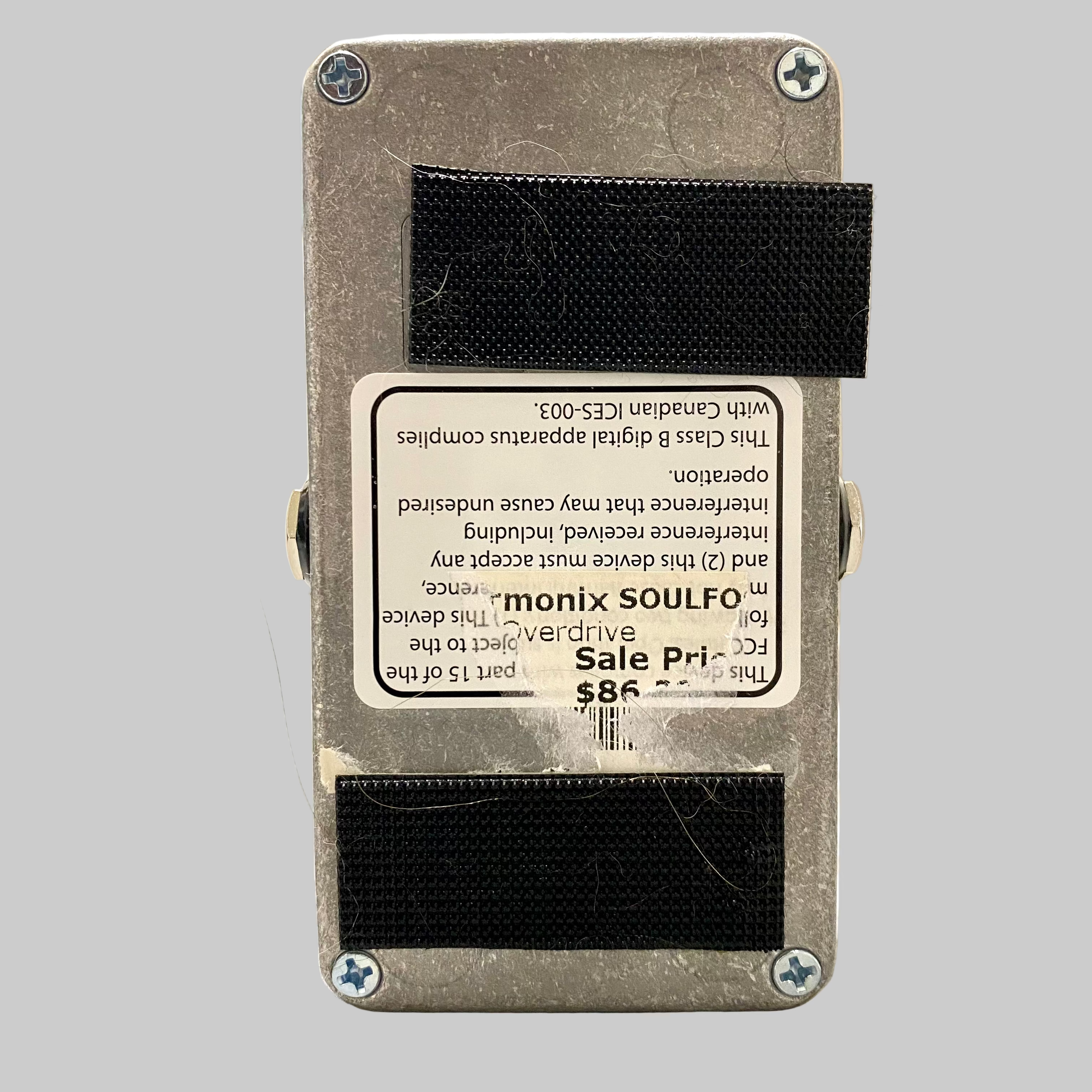 Guitar effects pedal with 'monix SOULFO' branding on a wooden surface.