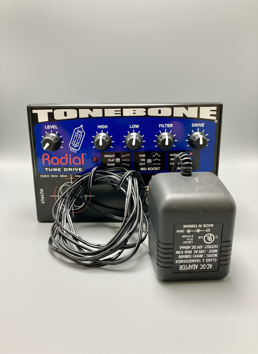 Radial Tonebone Tube Drive guitar effects pedal with power supply on a table.