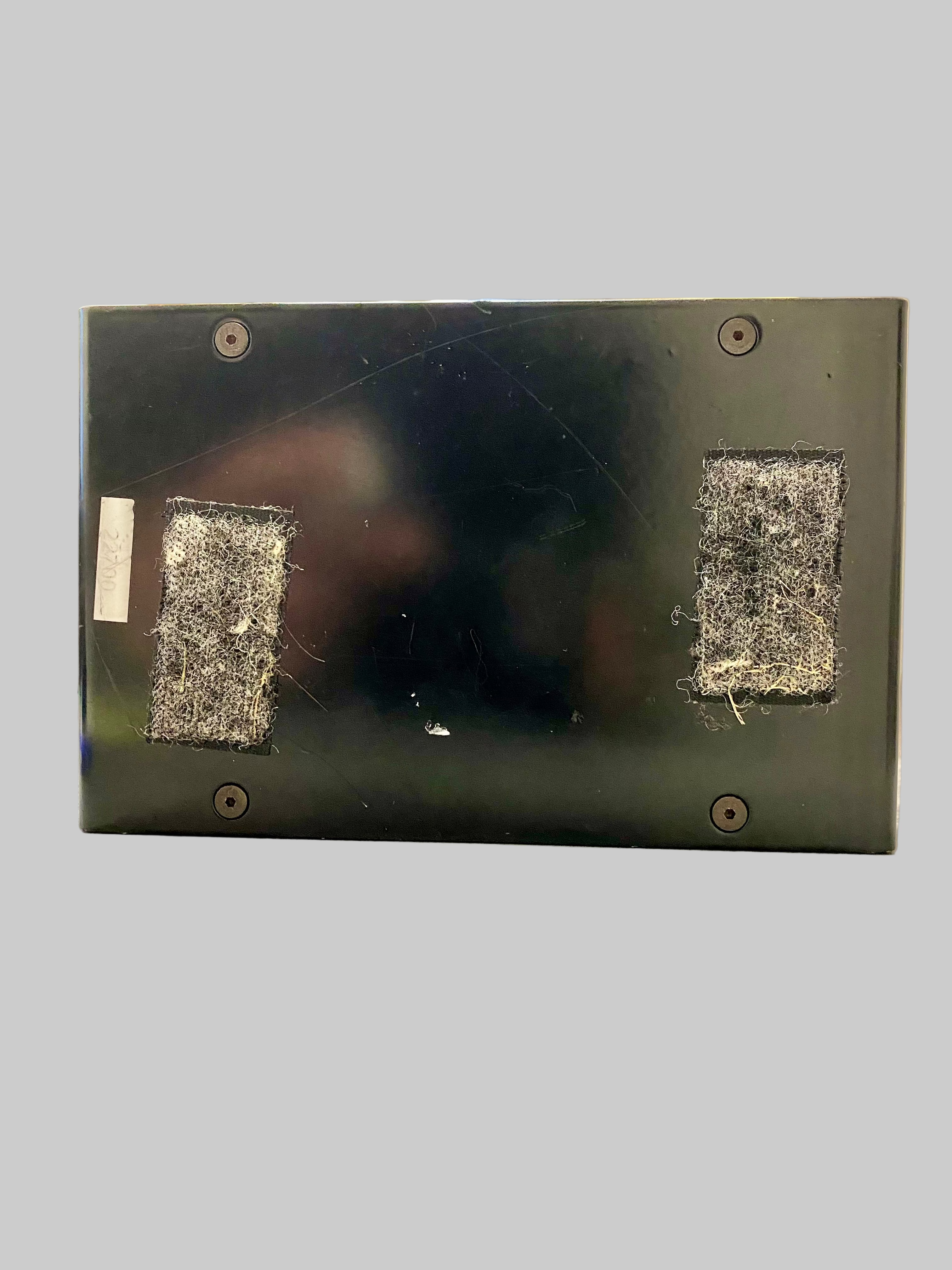 Black electronic device with textured surface on a reflective surface