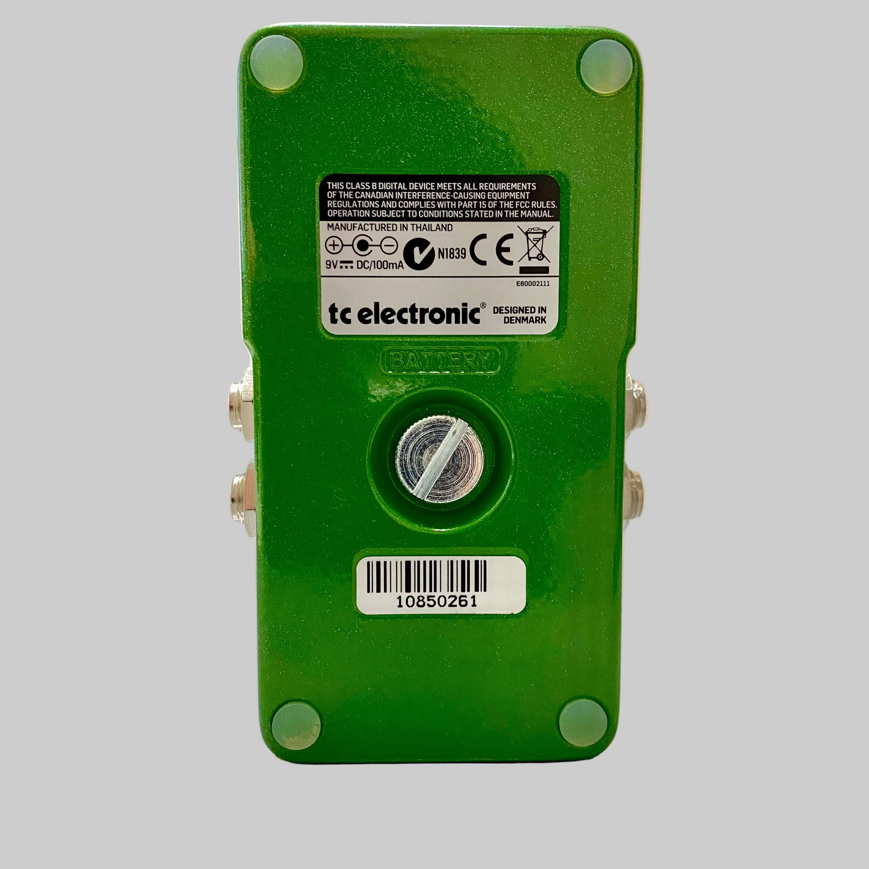 Green electronic device with 'tc electronic' branding on a wooden surface.