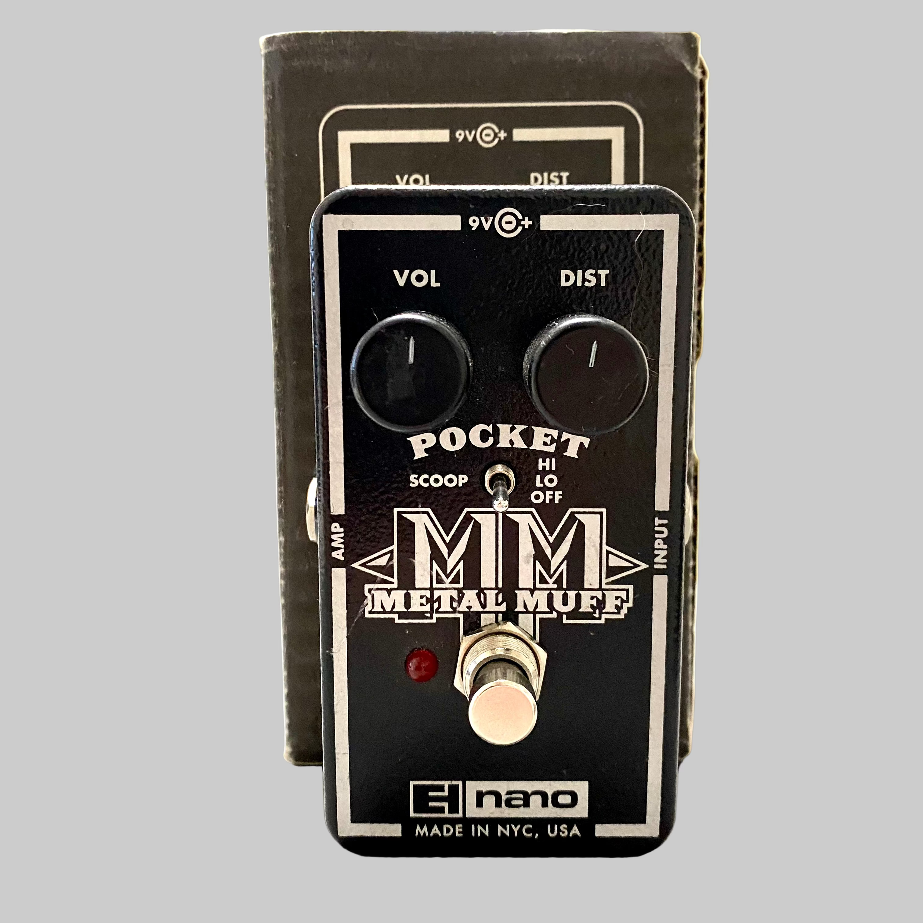 Guitar effects pedal with 'Metal Muff' branding on a blurred background