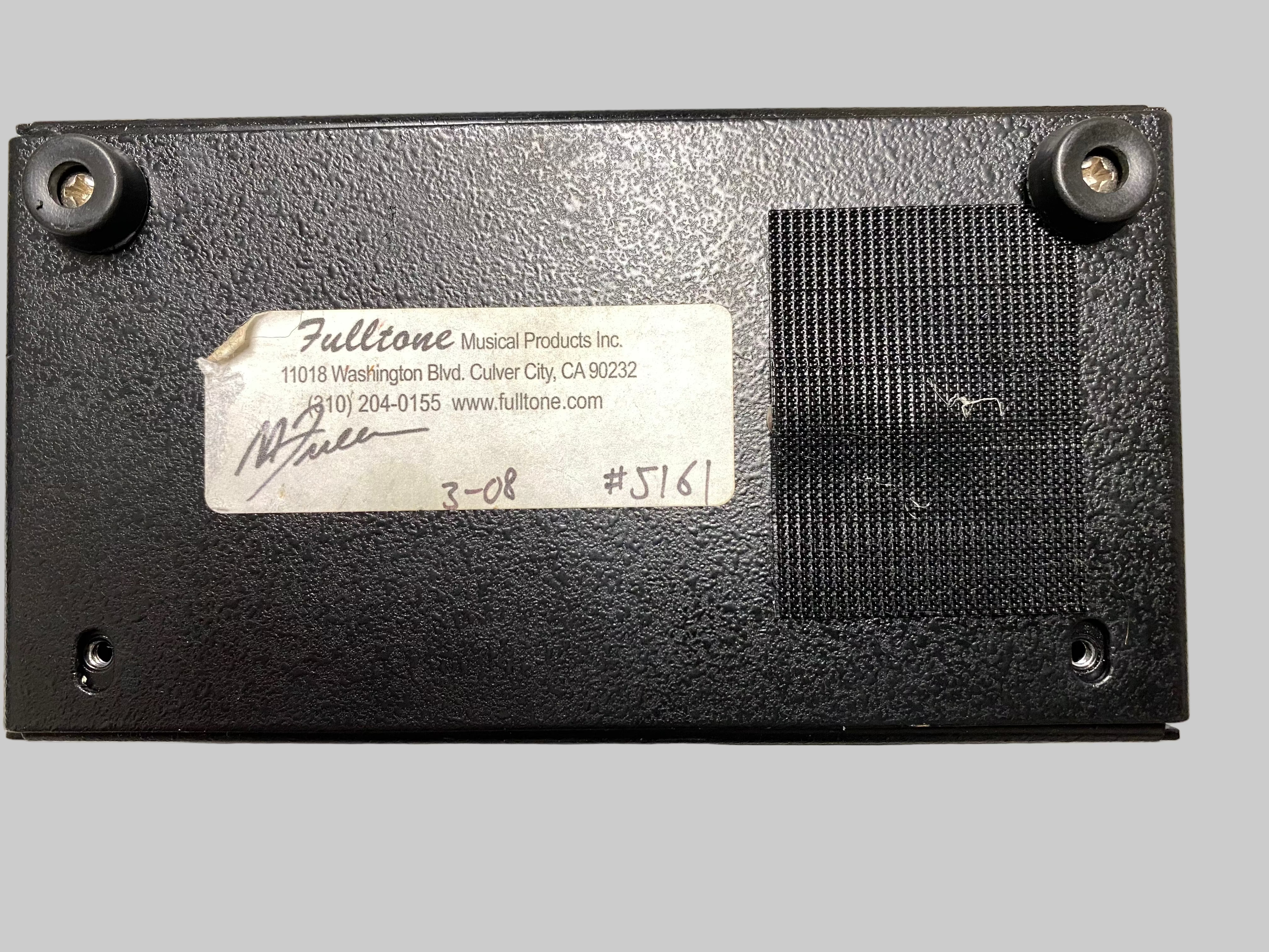 Back of a Fulltone guitar pedal with branding and model number on a gray surface