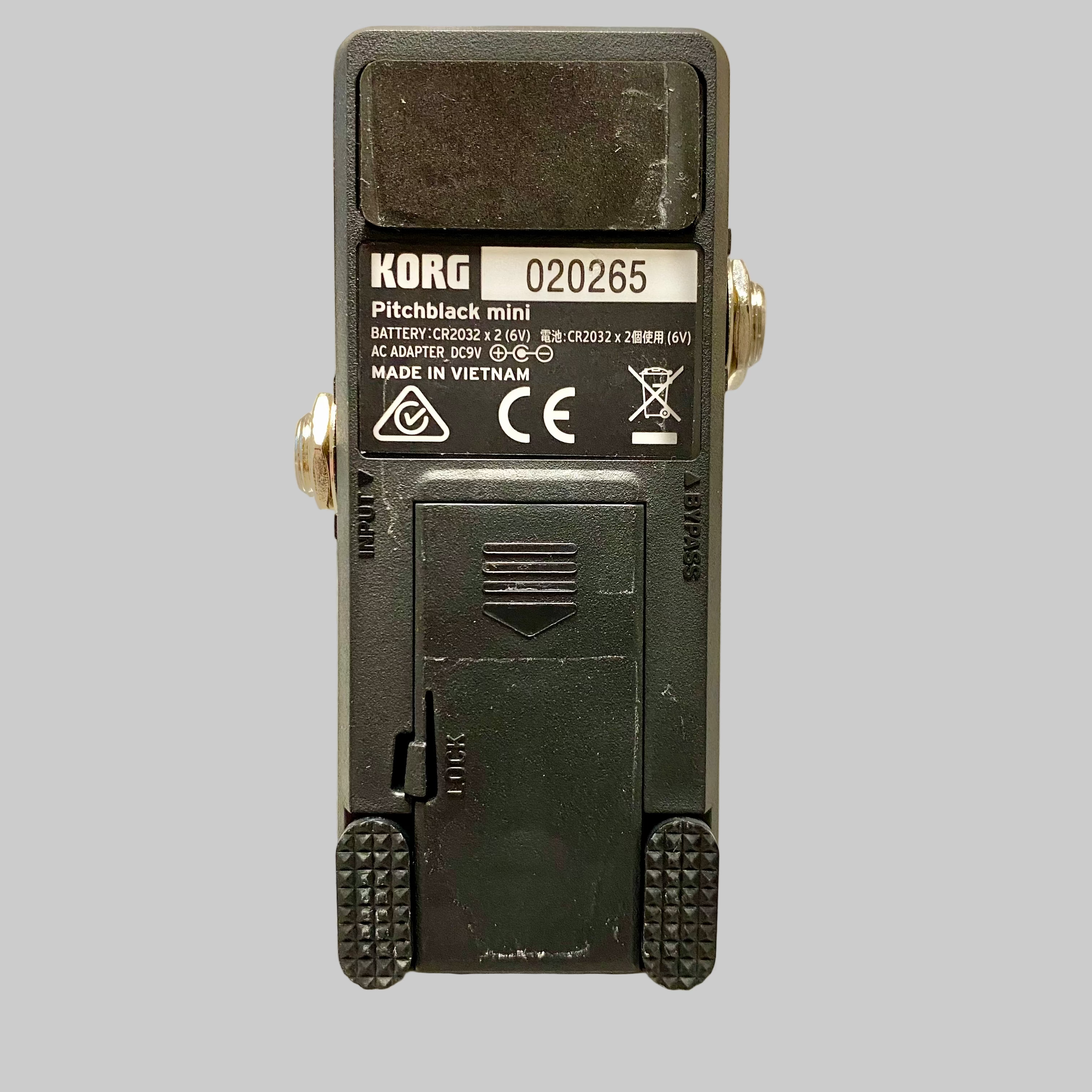 Back view of a KORG Pitchblack mini pedal on a textured surface