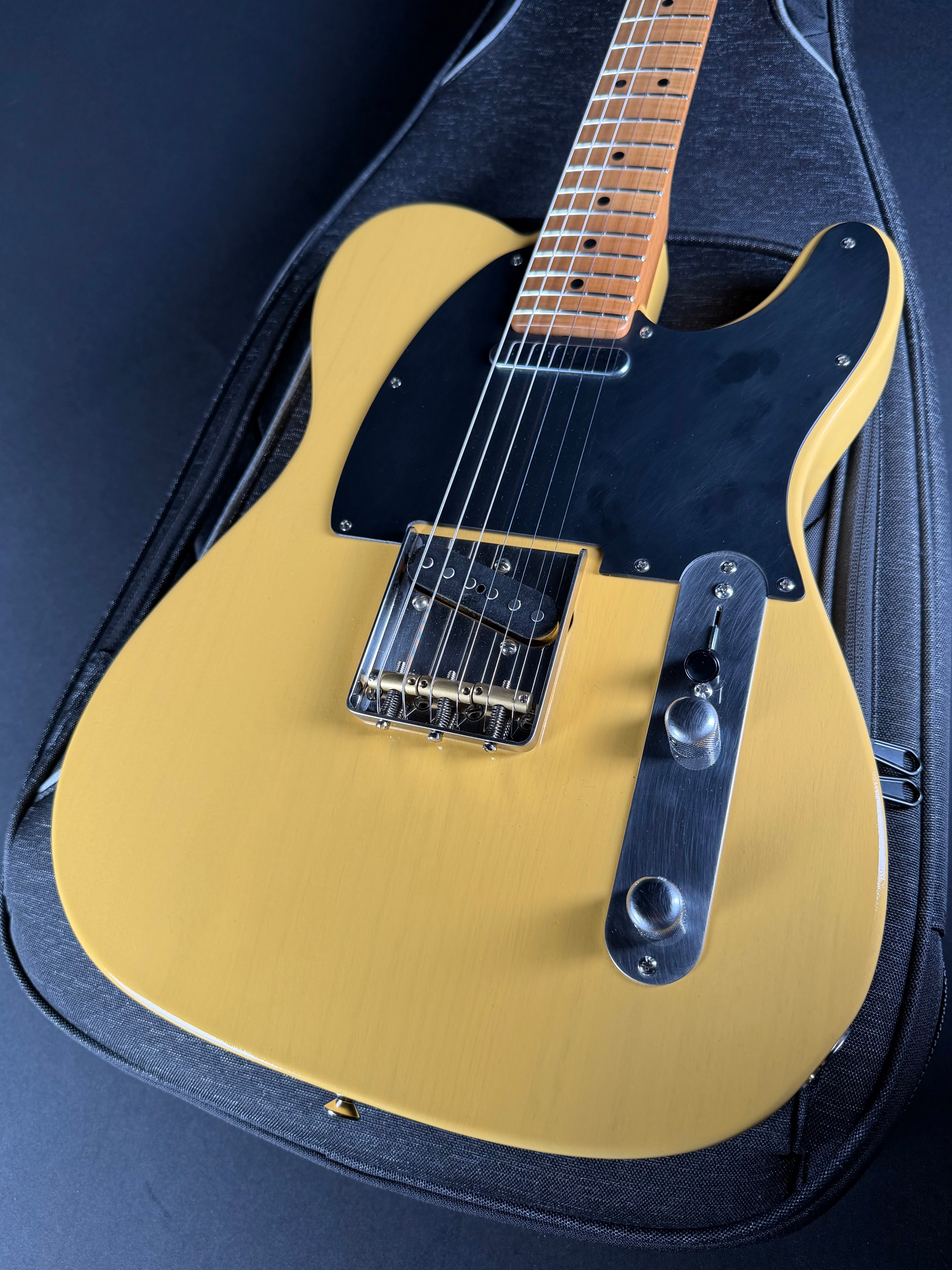 LSL T Bone electric guitar with a black pickguard on a matching case.