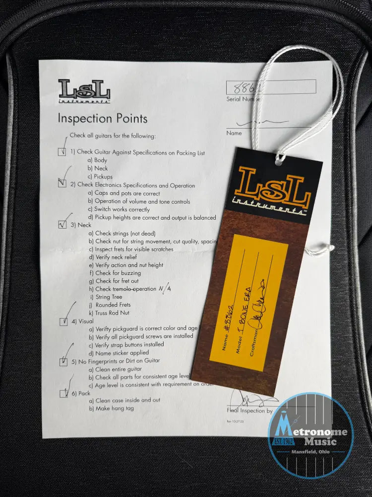 Inspection checklist and LSL branded tag on a guitar case