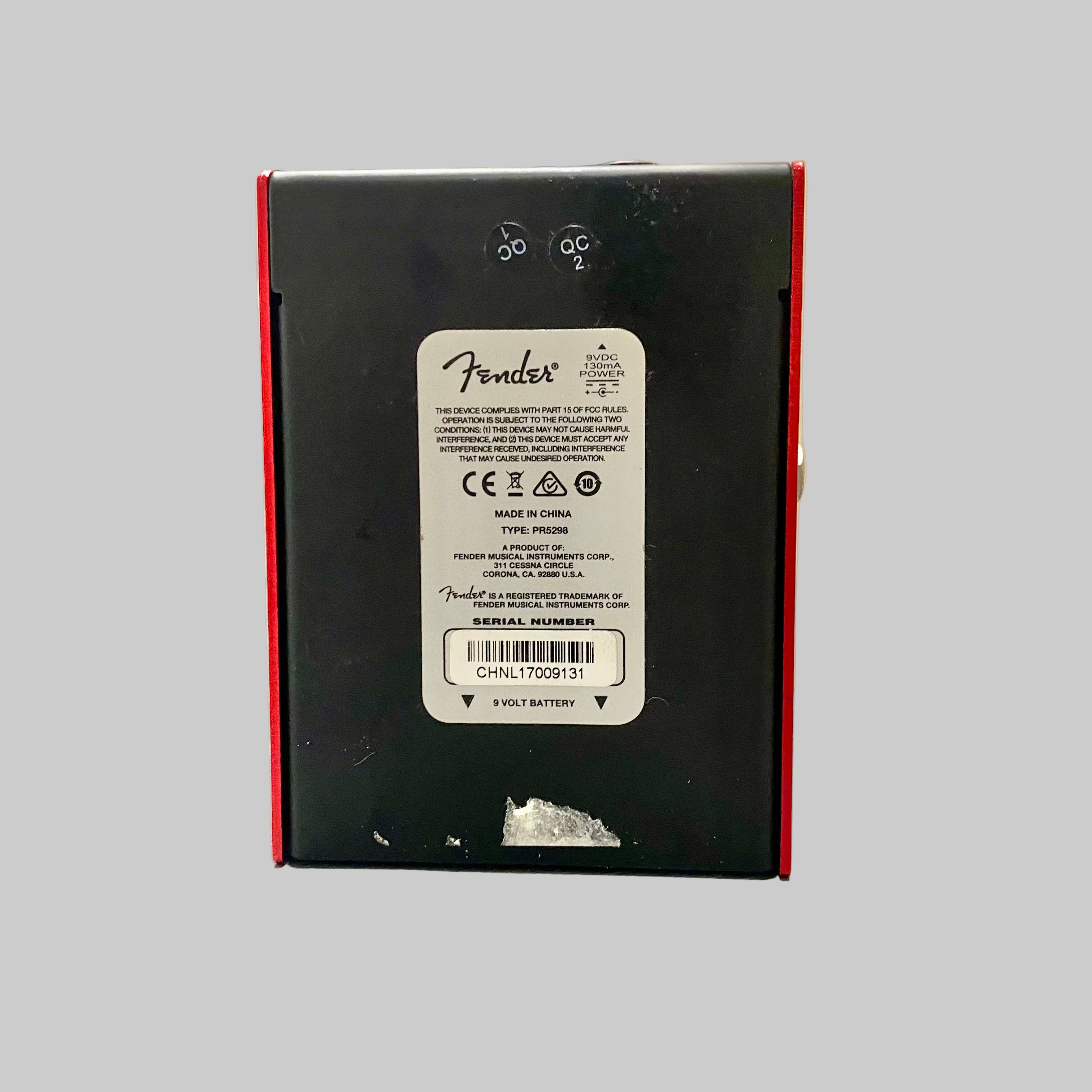 Back of a Fender electronic device on a table with a blurred background