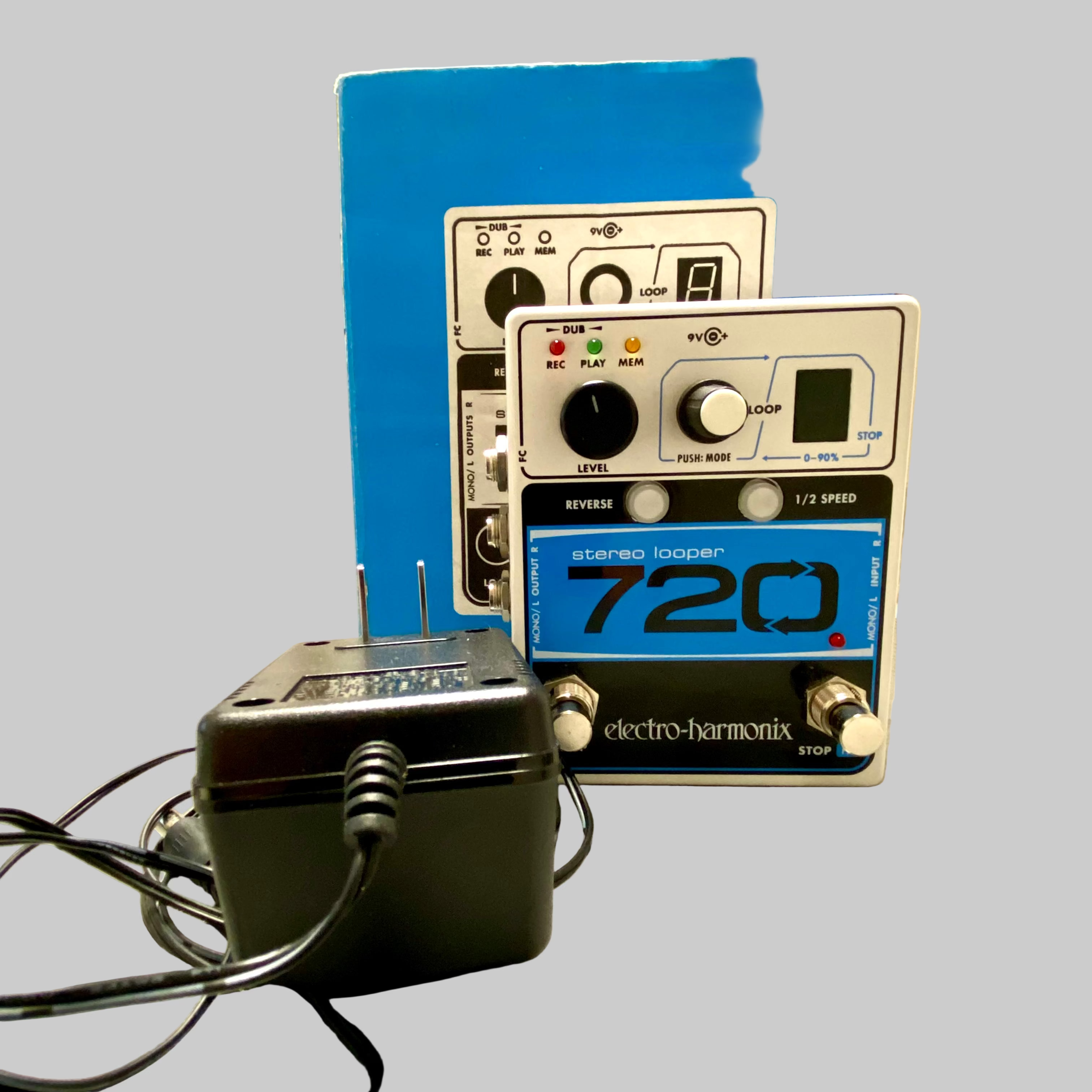 Electro-Harmonix stereo looper 720 pedal on a table with power adapter.