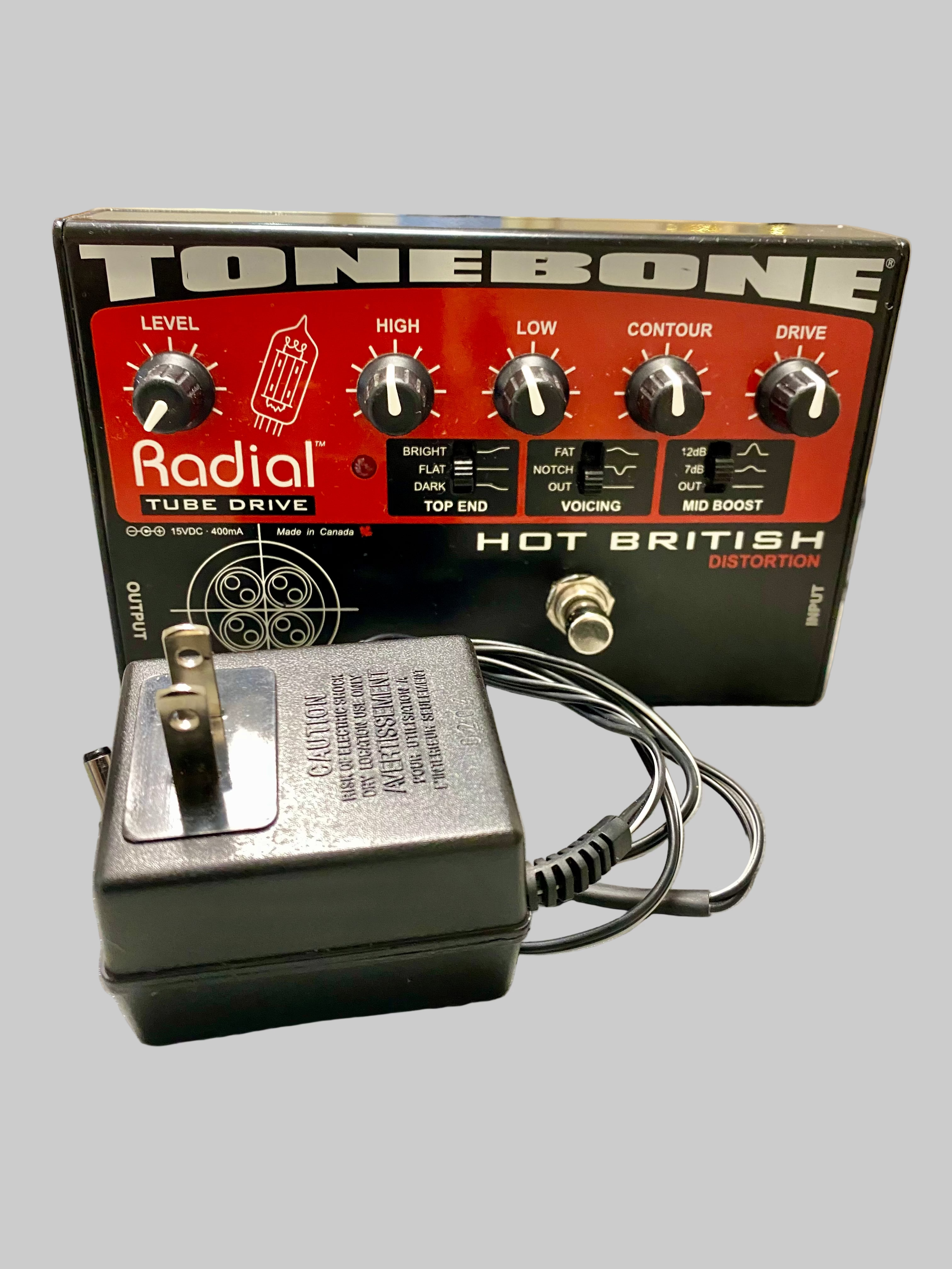 Radial Tonebone Tube Drive guitar effects pedal with power supply on a table.