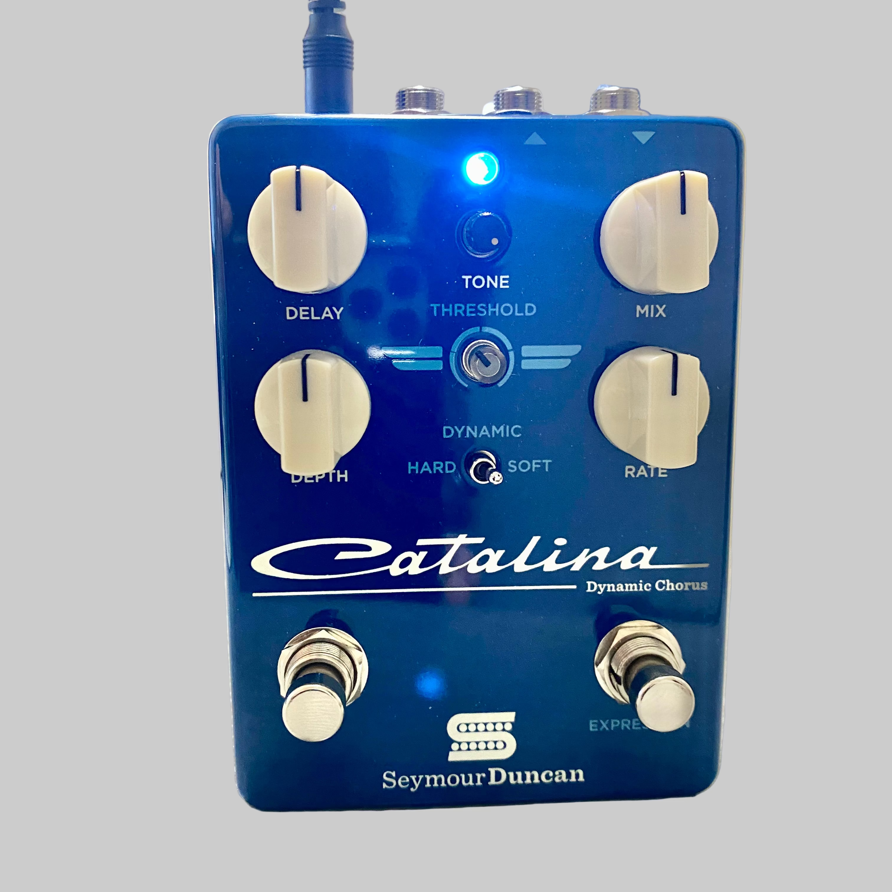 Blue guitar effects pedal with 'Catalina' and 'Seymour Duncan' branding on a wooden surface.