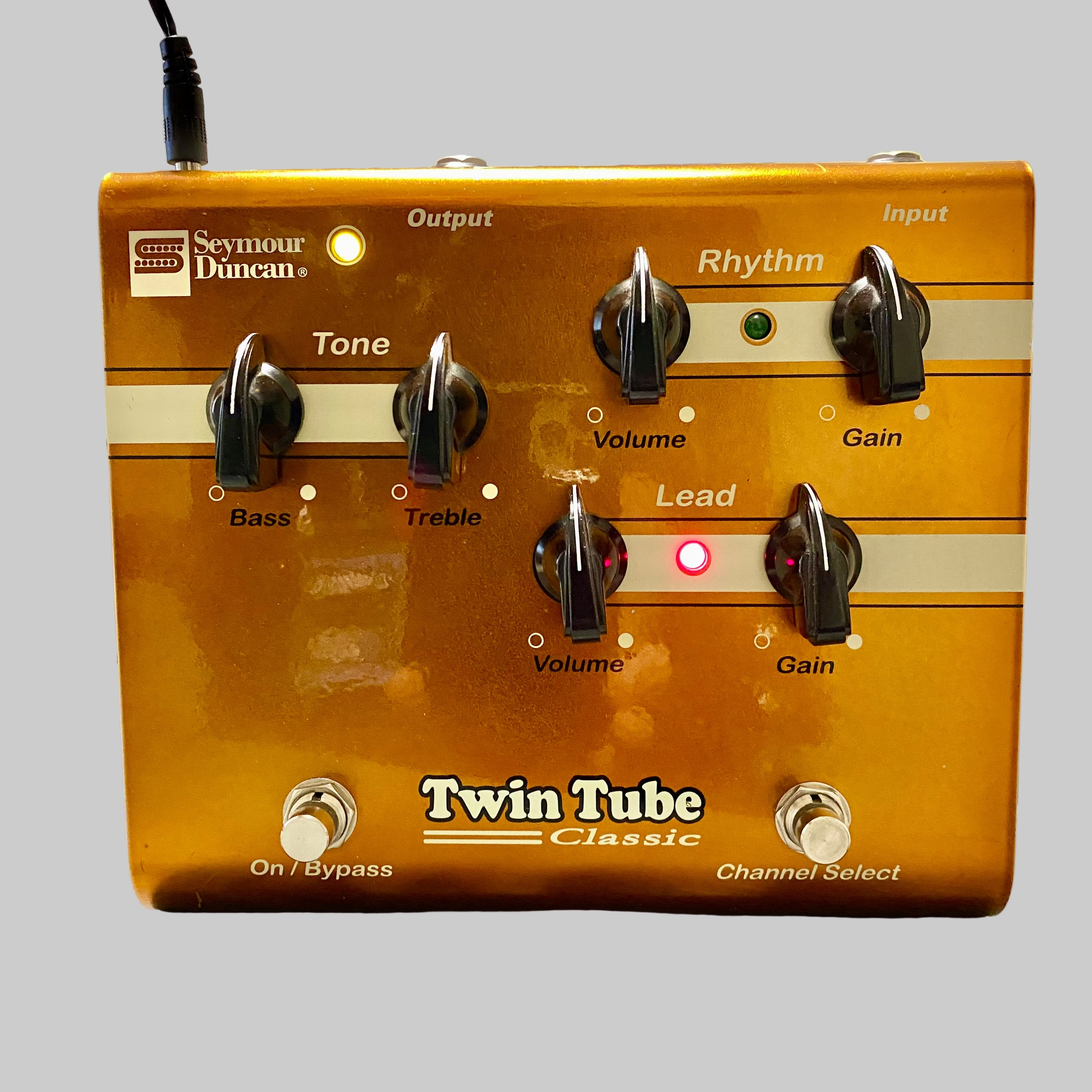 Guitar effects pedal with 'Seymour Duncan' branding on a wooden surface.