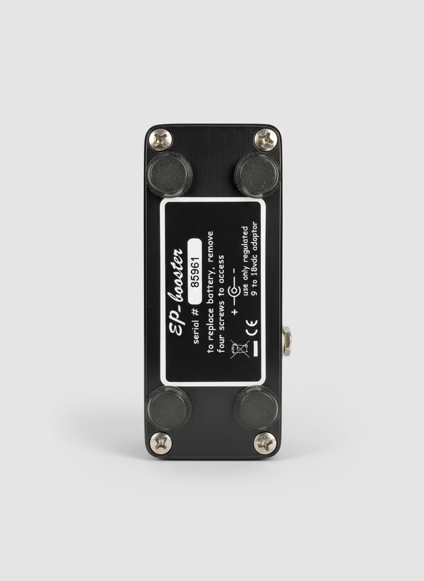 Black electronic device with a label on a wooden surface