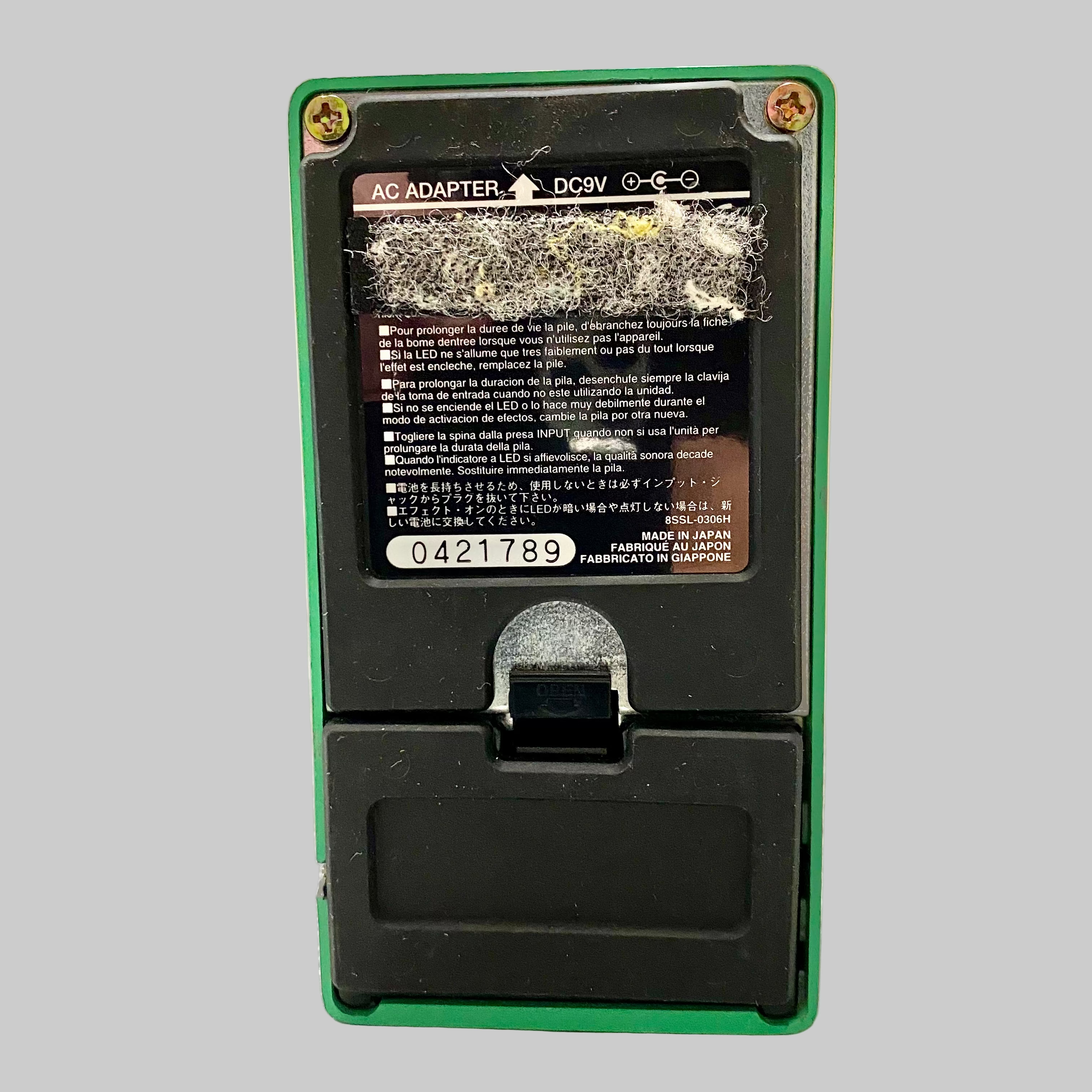 Green electronic device with a black screen on a gray surface