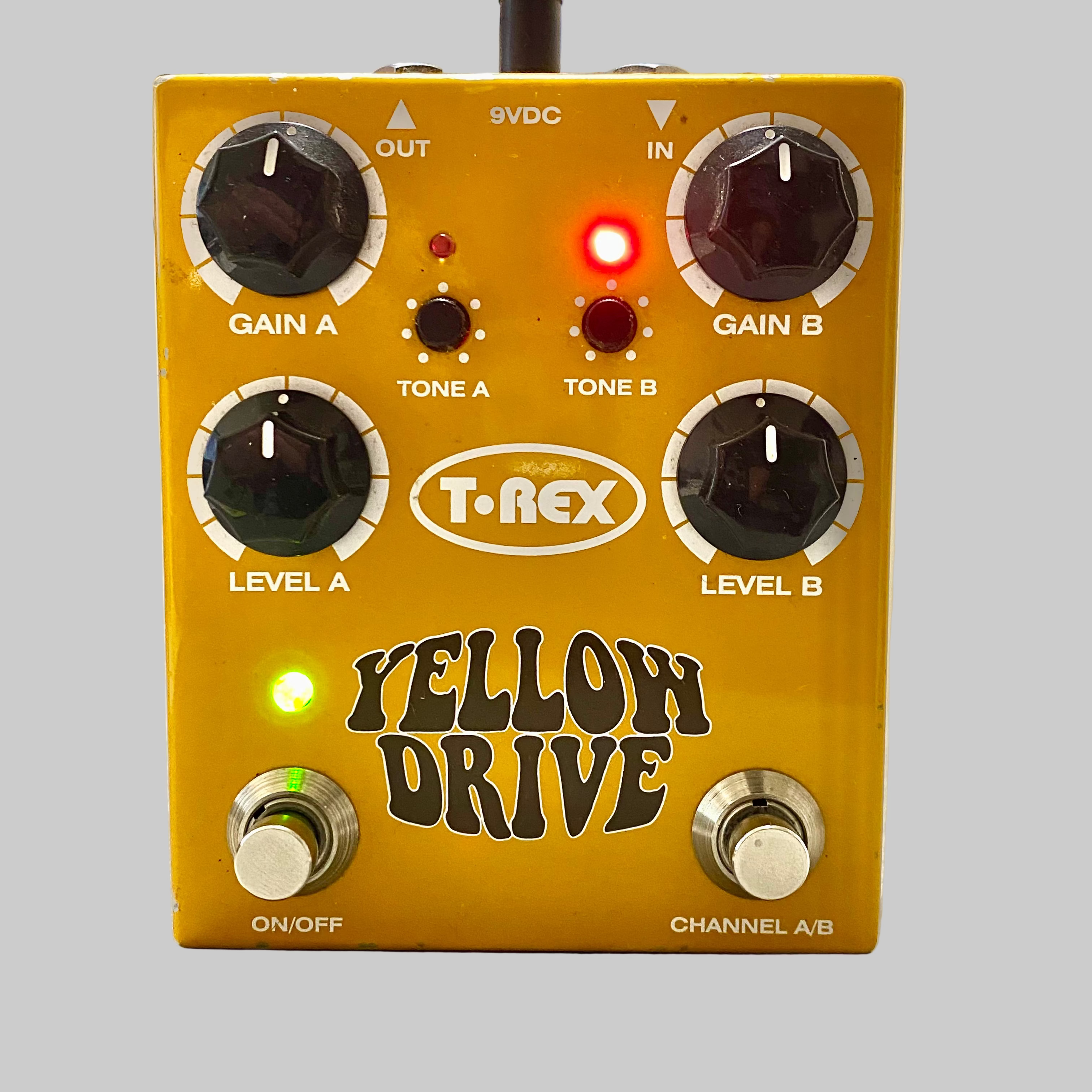 T-Rex Yellow Drive guitar effects pedal on a wooden surface