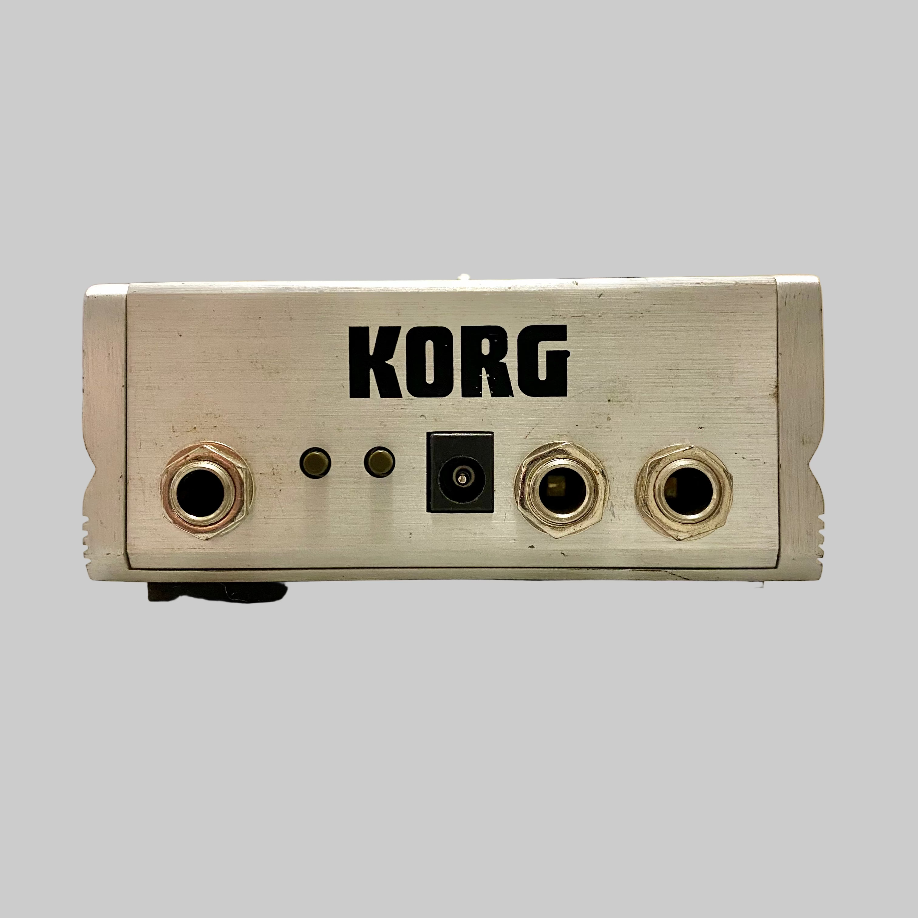 Korg electronic device on a table with a blurred indoor background