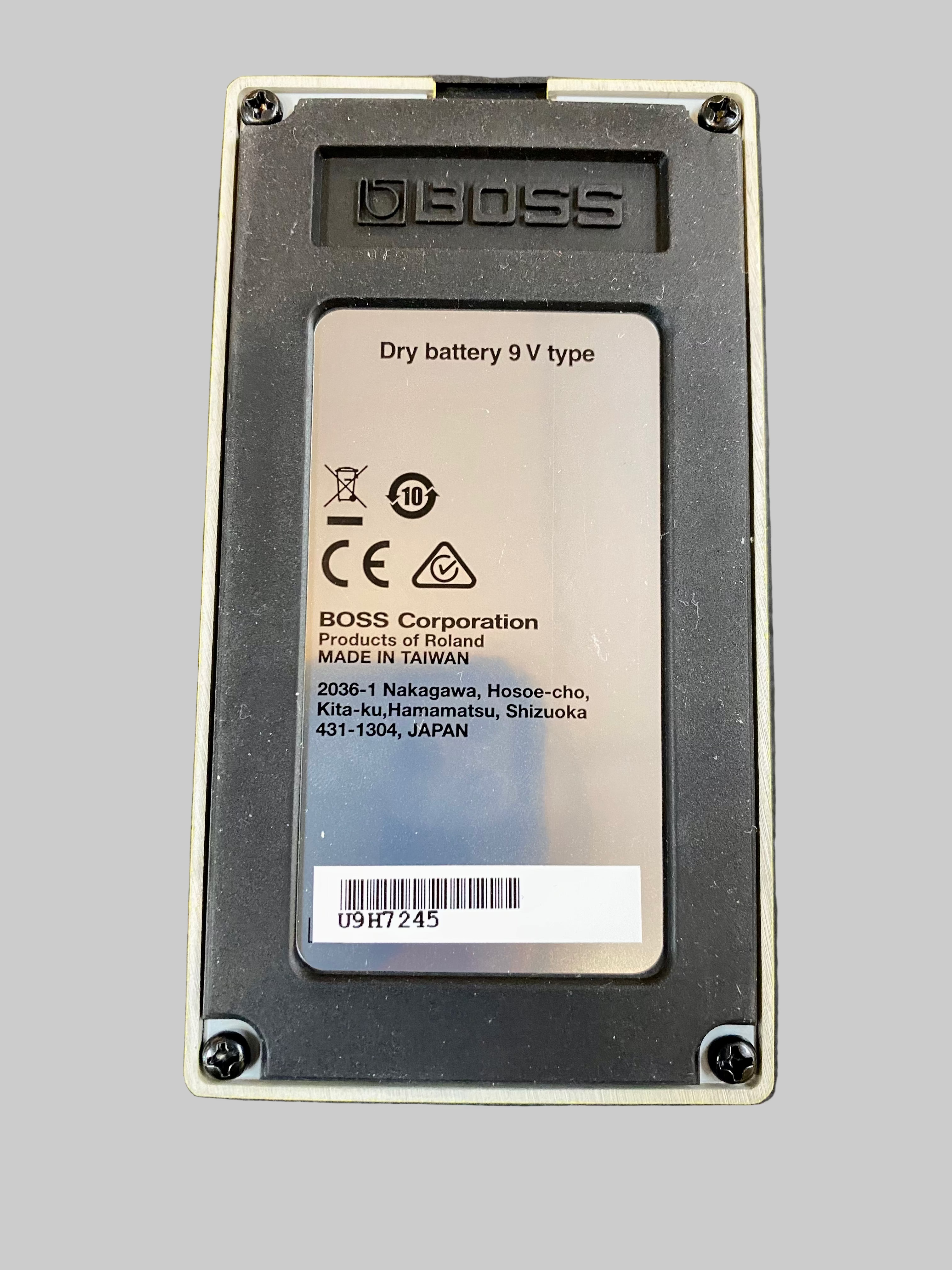 9V battery with BOSS branding on a textured black surface