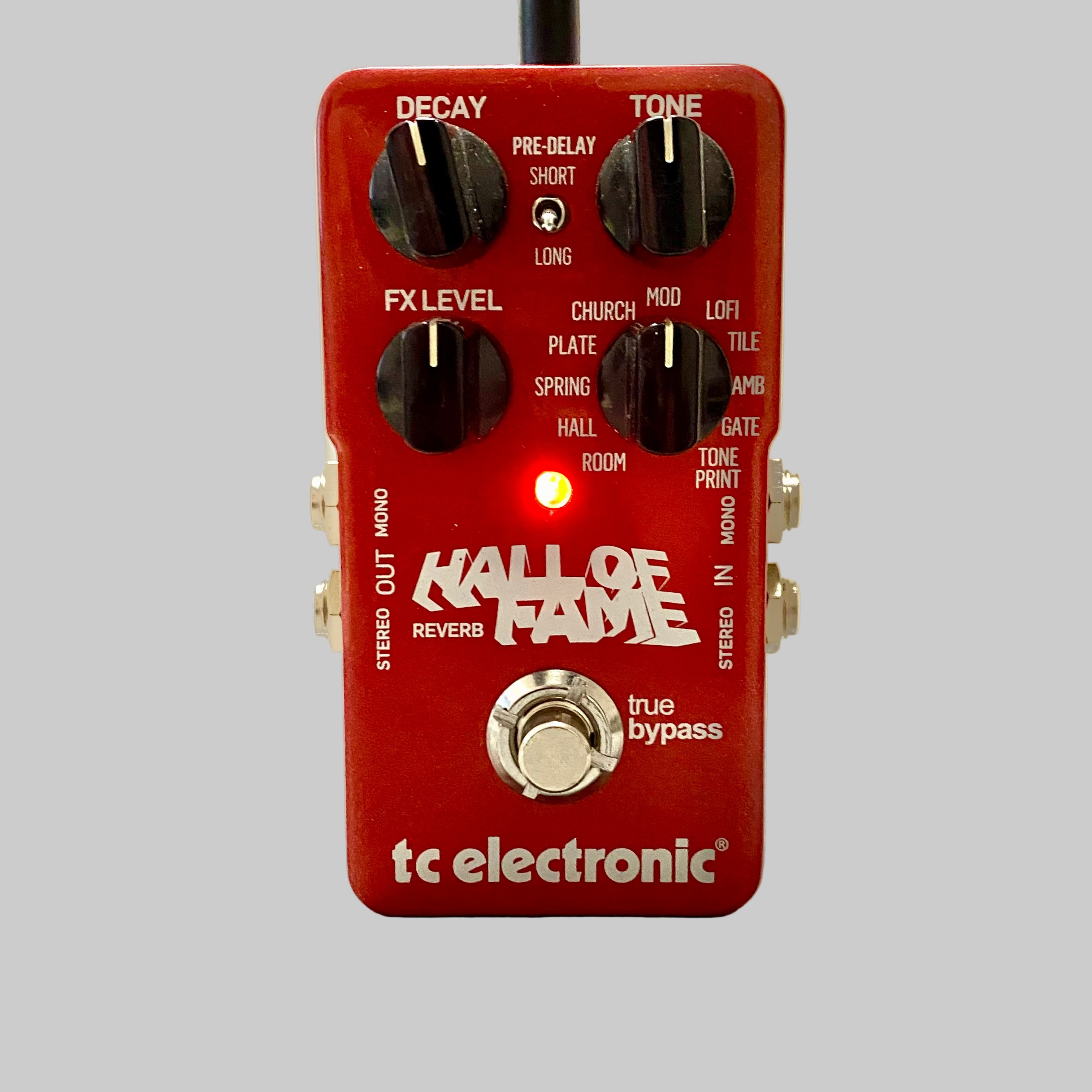 Red tc electronic Hall of Fame guitar effects pedal on a wooden surface