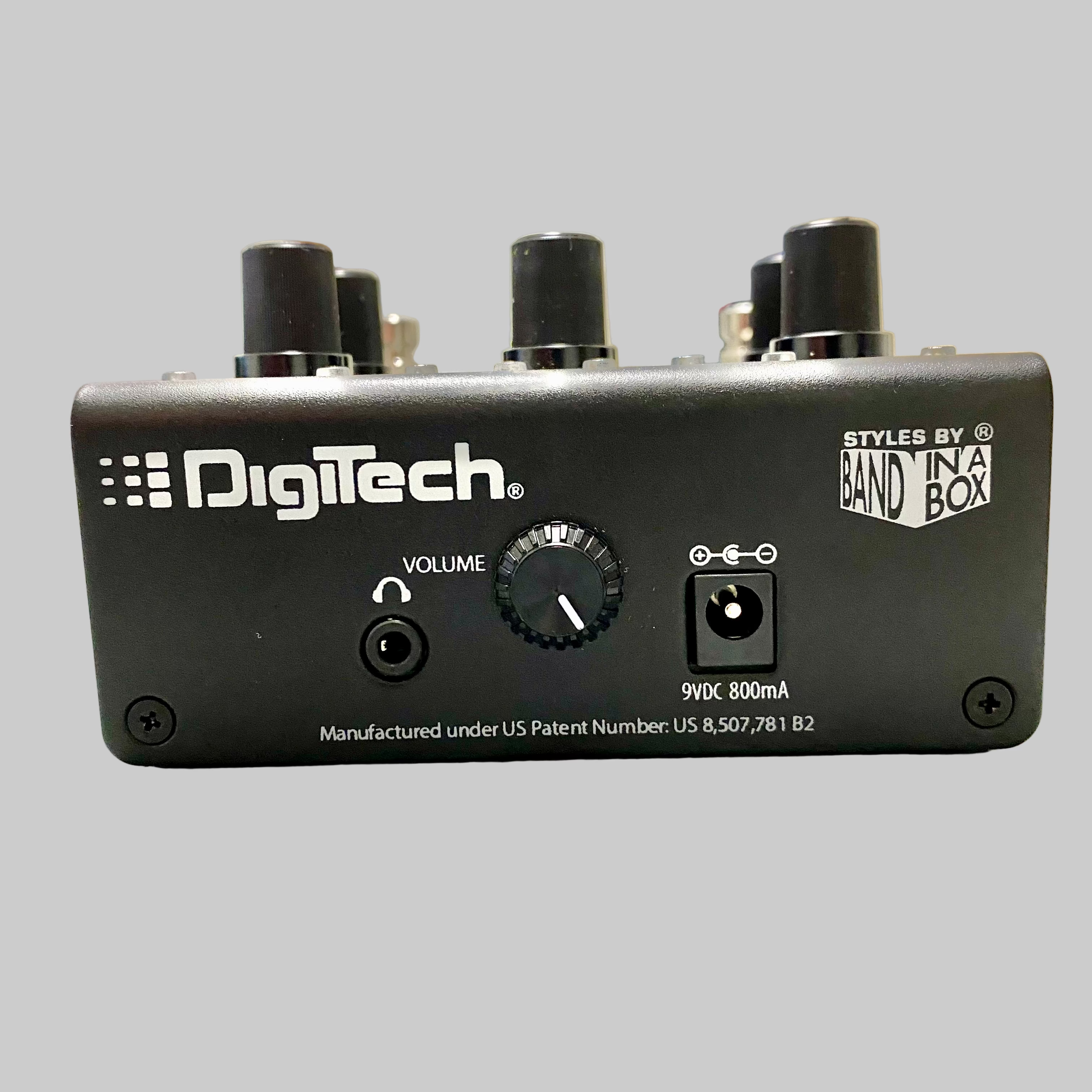DigiTech guitar effects pedal on a table with a blurred indoor background