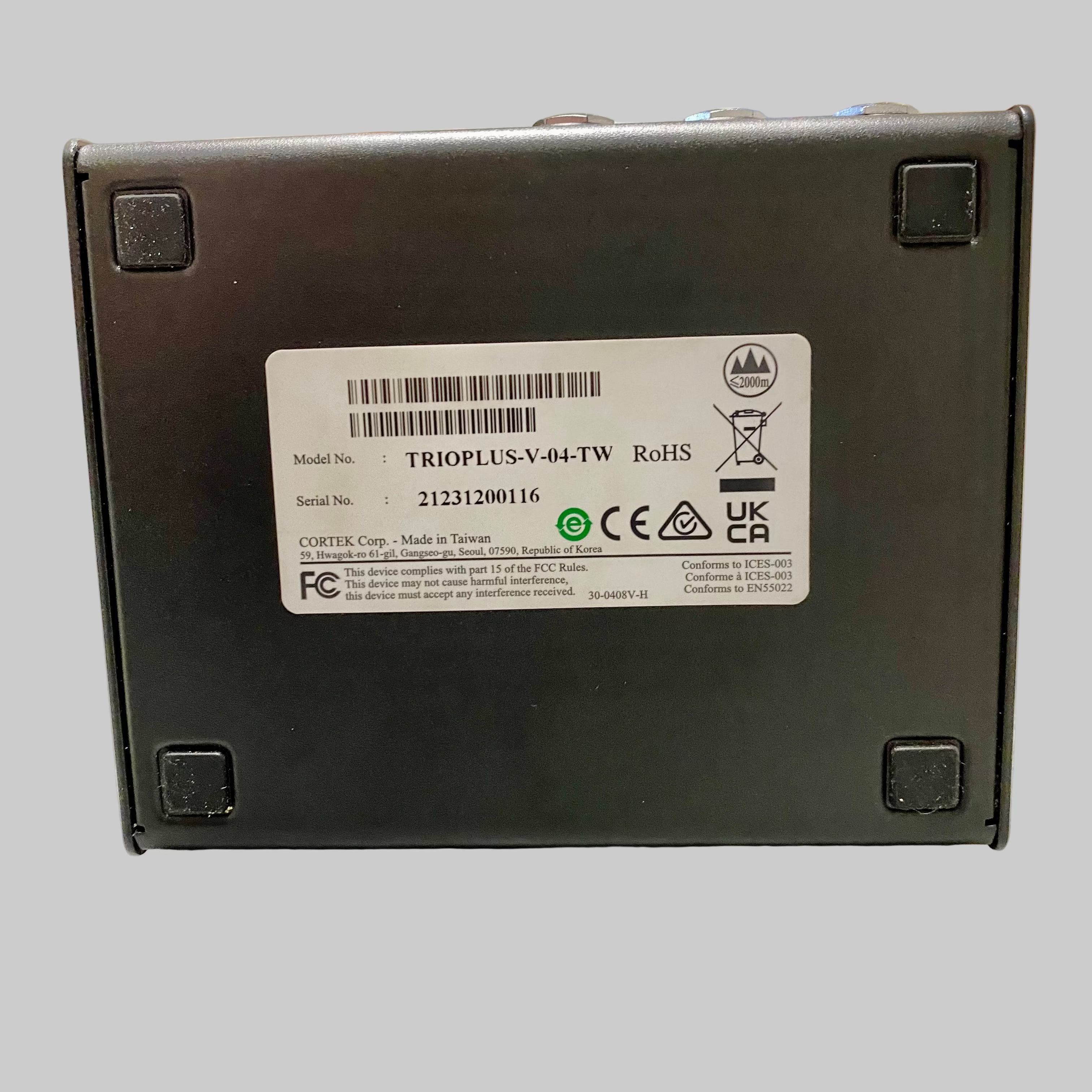 Black electronic device with a label on a wooden surface