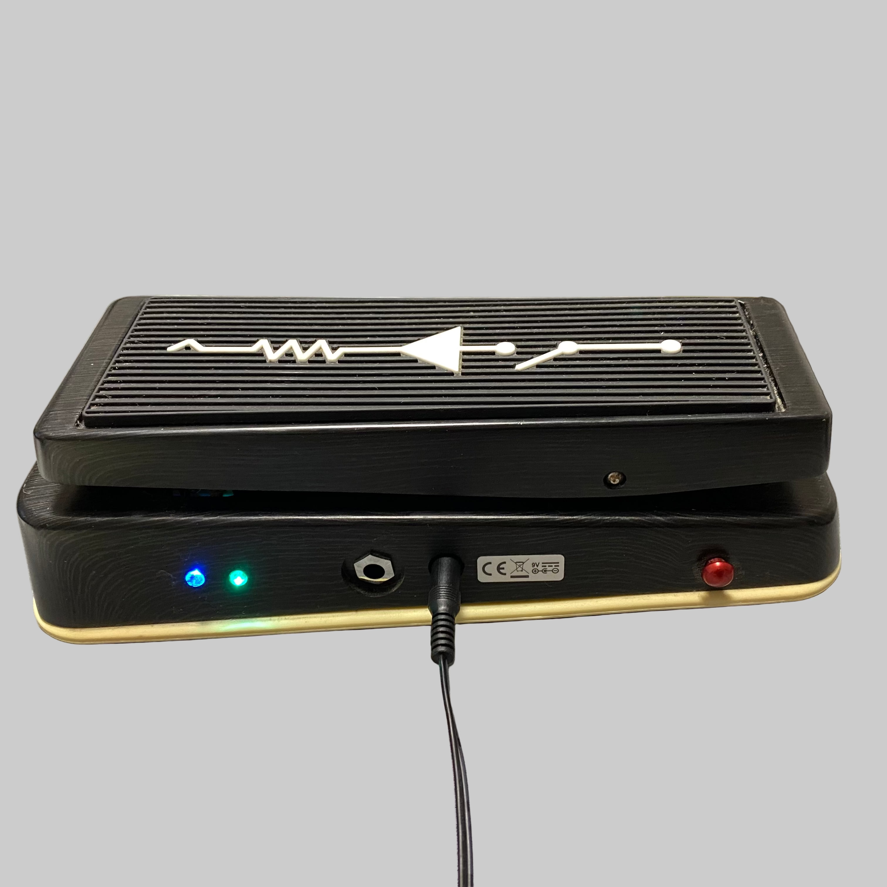 Black electronic device with LED lights on a gray surface