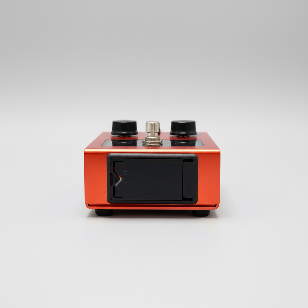 Orange electronic device with knobs on a gray surface