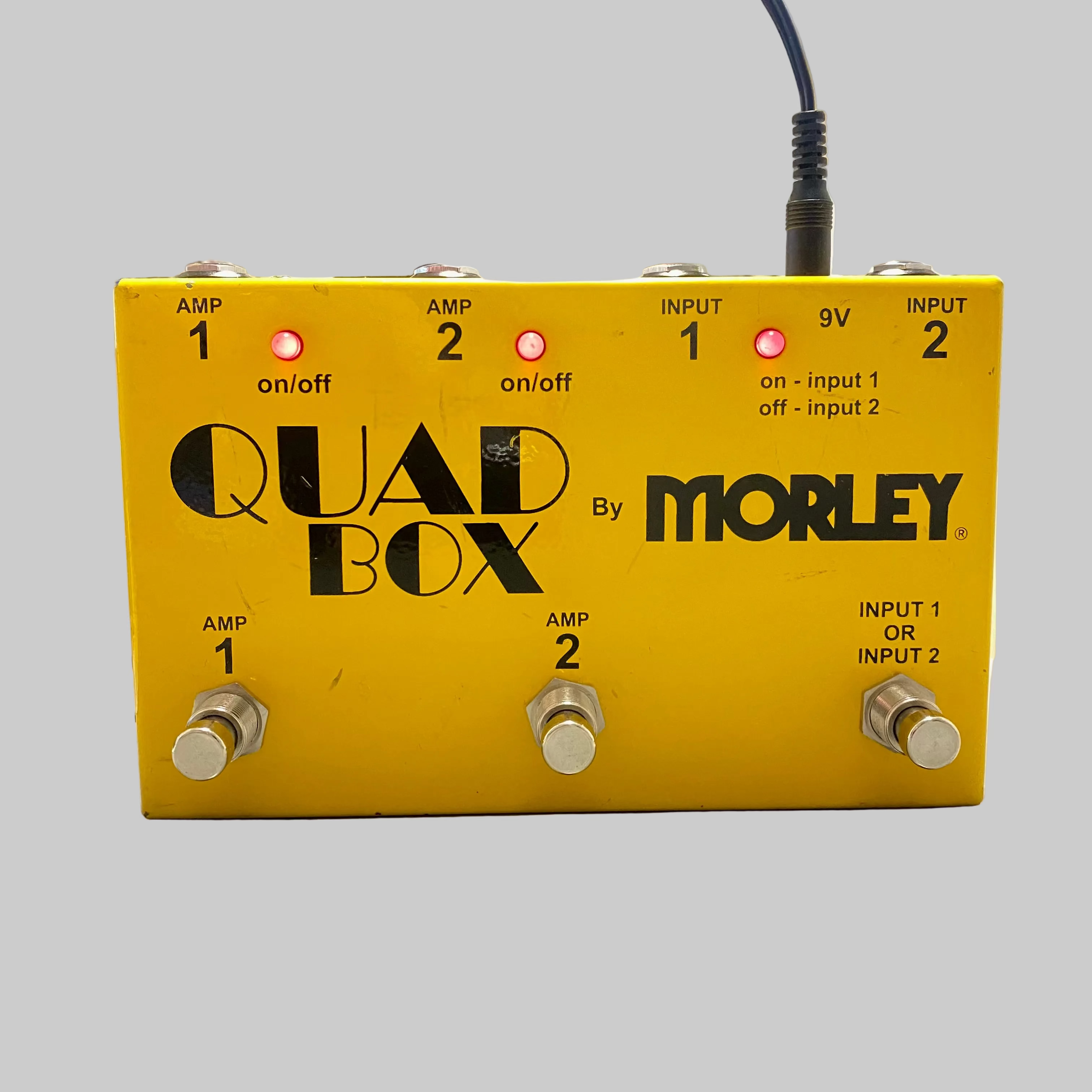 Yellow Quad Box by Morley guitar effects pedal on a desk