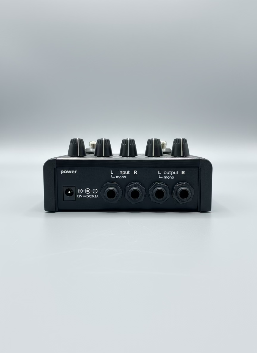 Back panel of an audio mixer with various connectors on a gray surface.