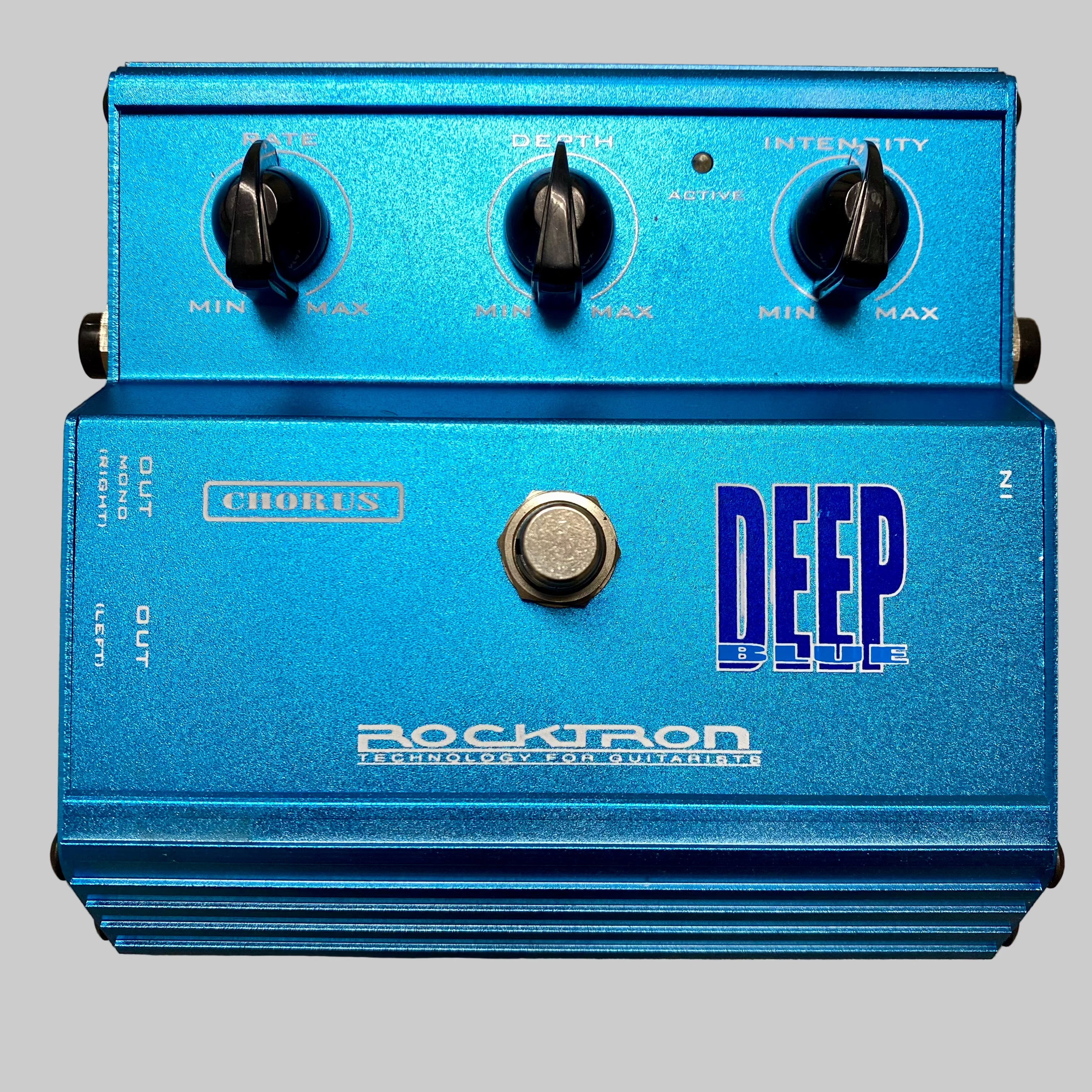 Blue guitar effects pedal with 'Rocktron' branding on a wooden surface