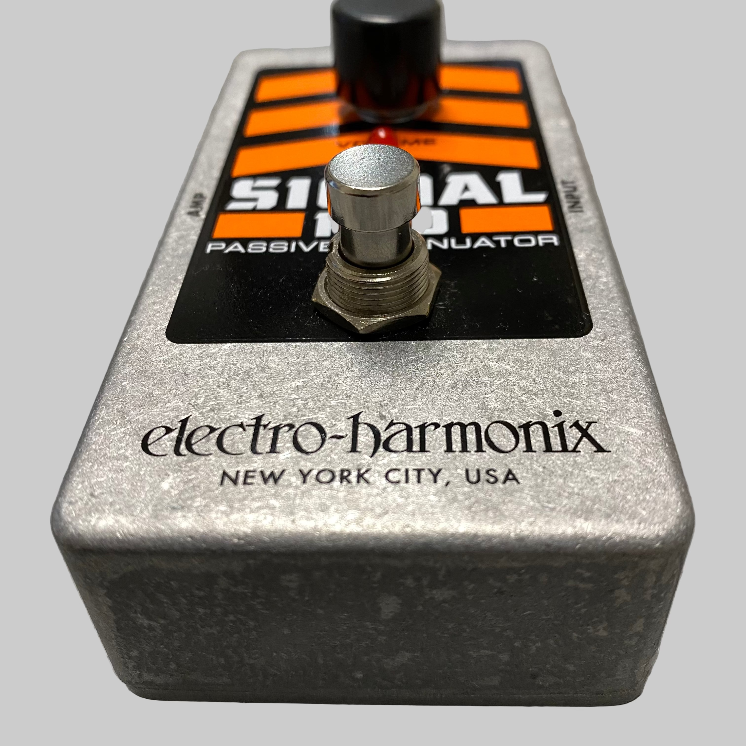 Electro-Harmonix guitar effects pedal on a wooden surface