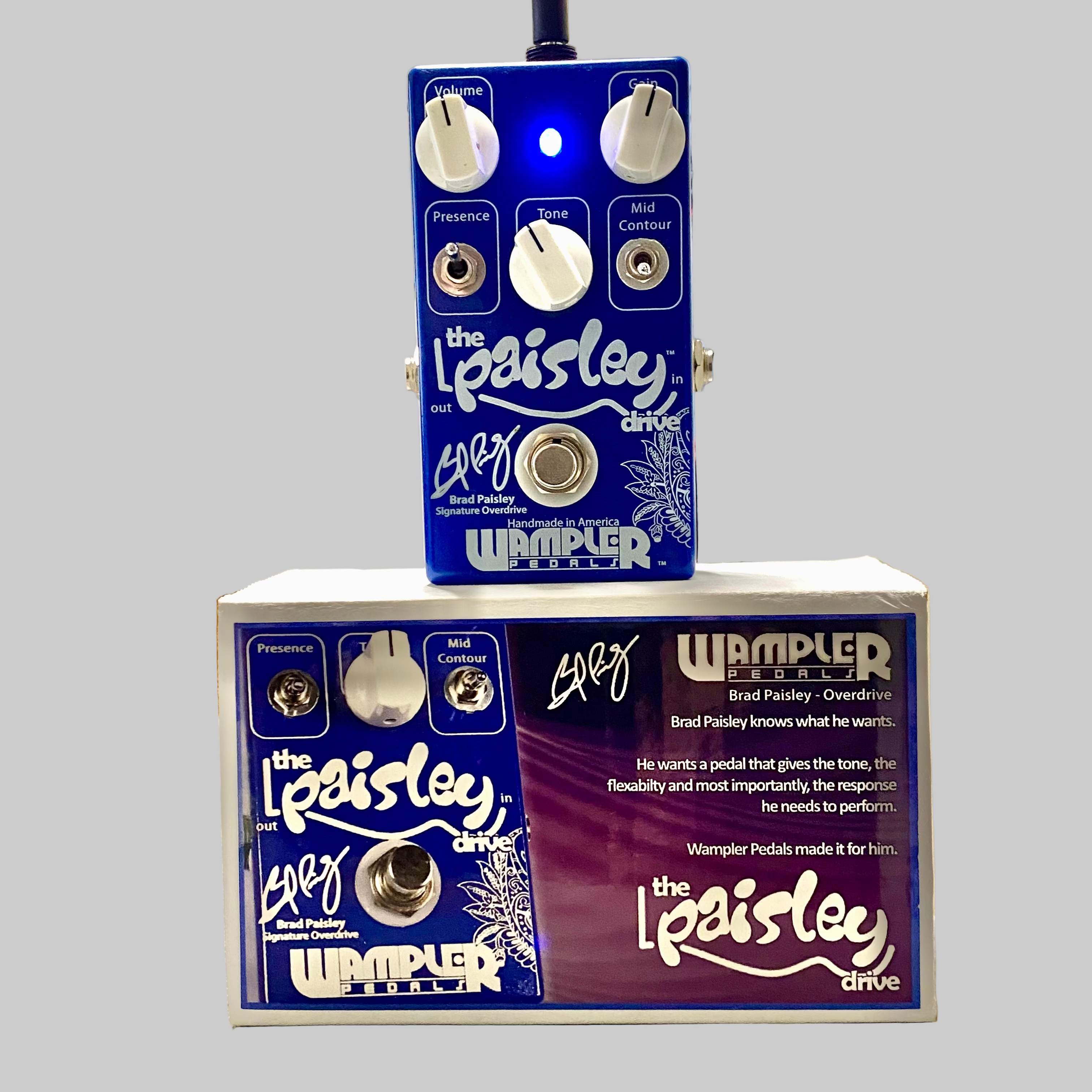 Wampler Paisley Drive guitar effects pedal with packaging on a table.