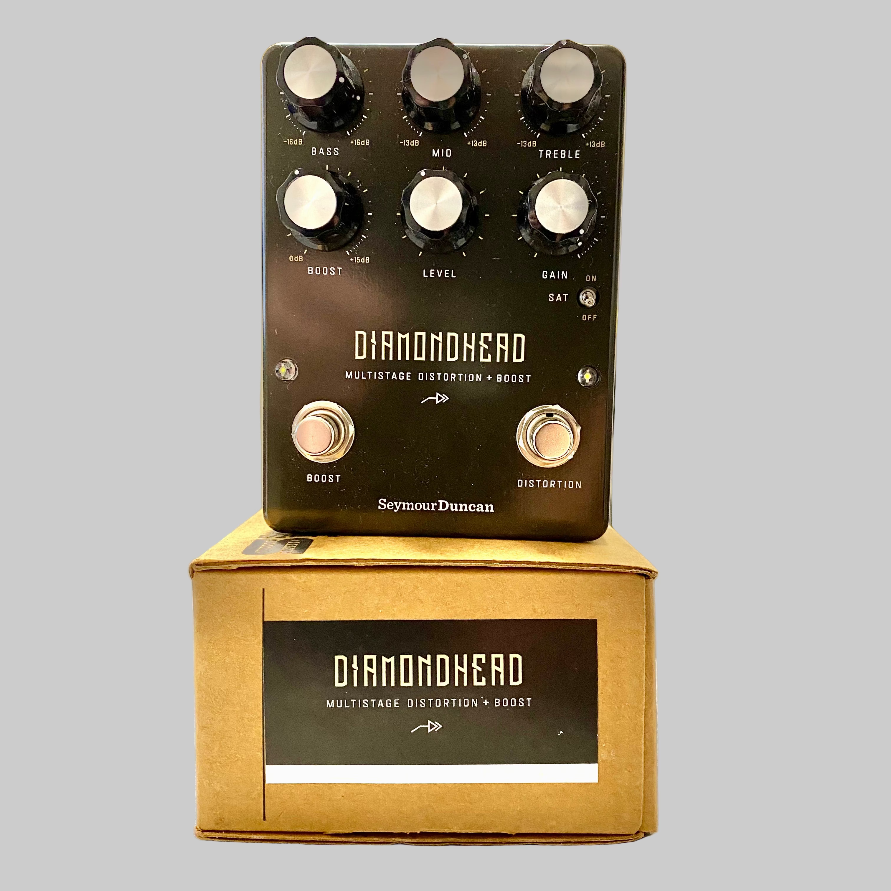Guitar effects pedal with 'Diamondhead' branding on a wooden stand.
