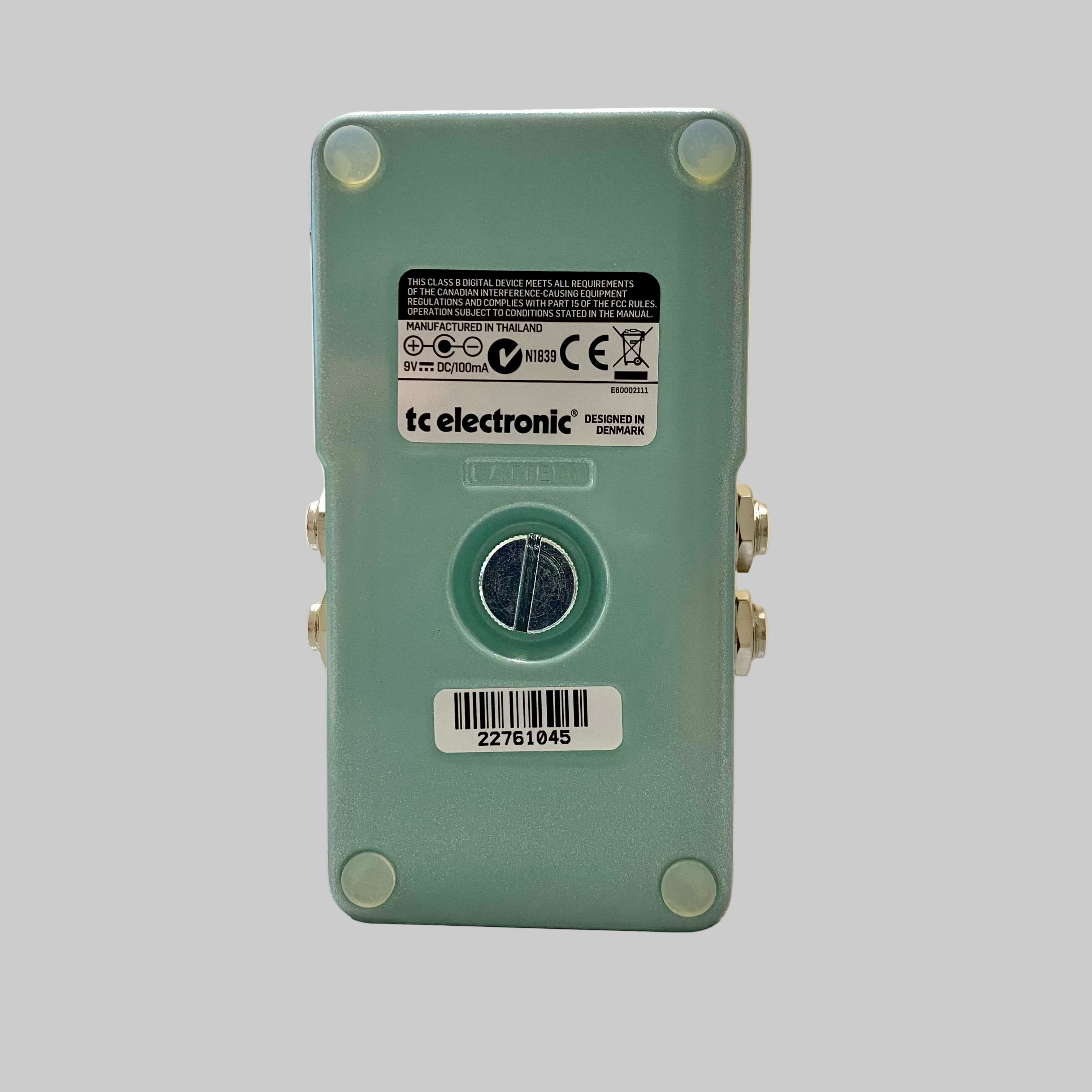 Green electronic device with 'tc electronic' branding on a wooden surface.