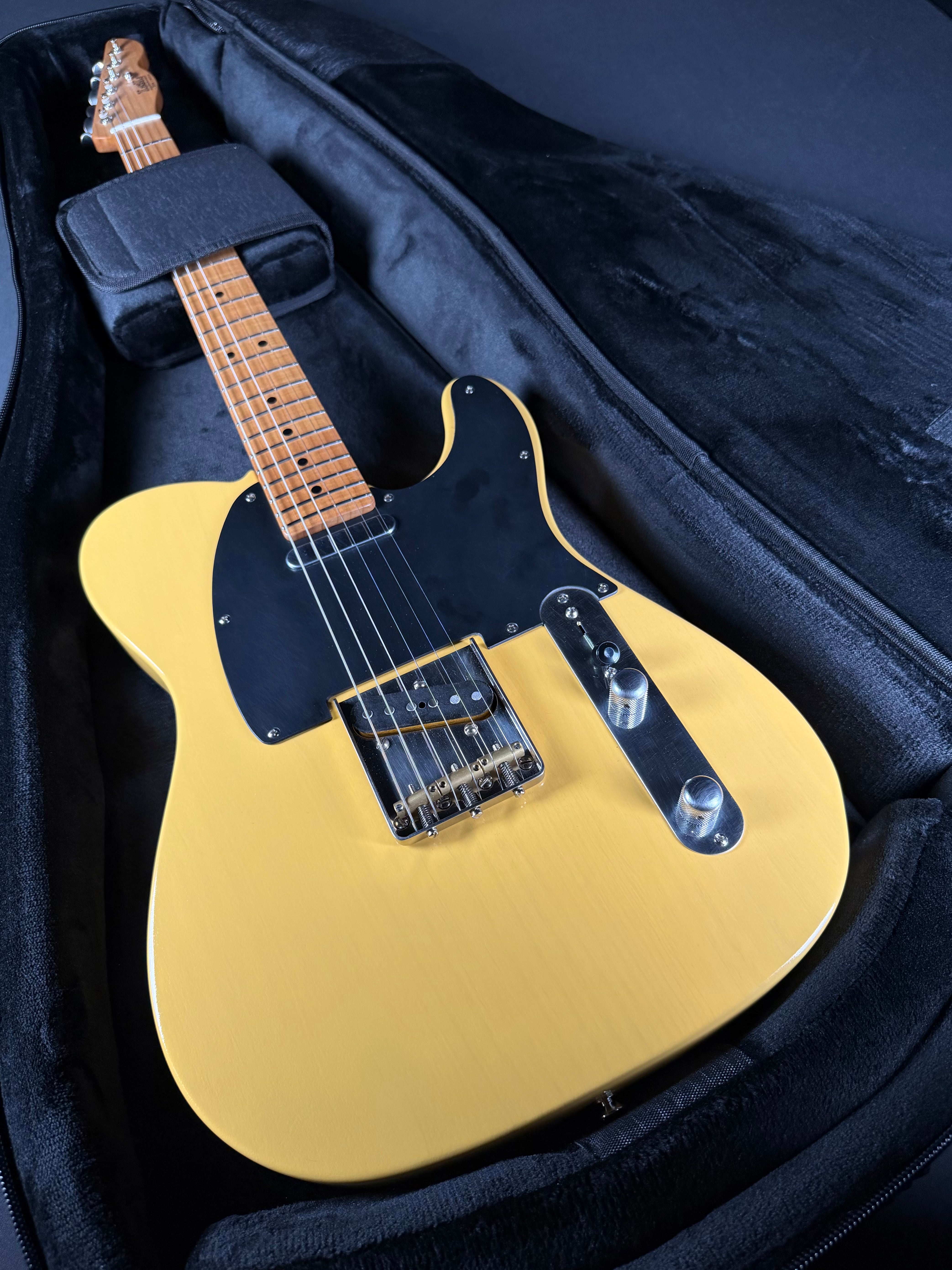 Butterscotch electric guitar in a black case