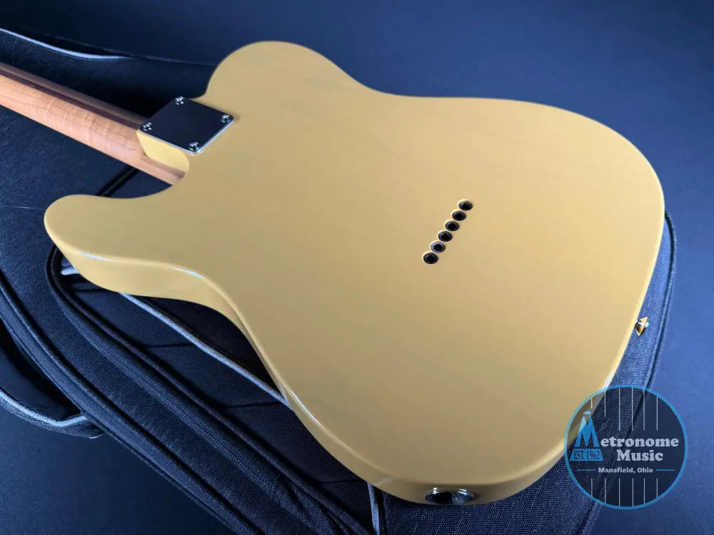 Beige electric guitar on a blue background