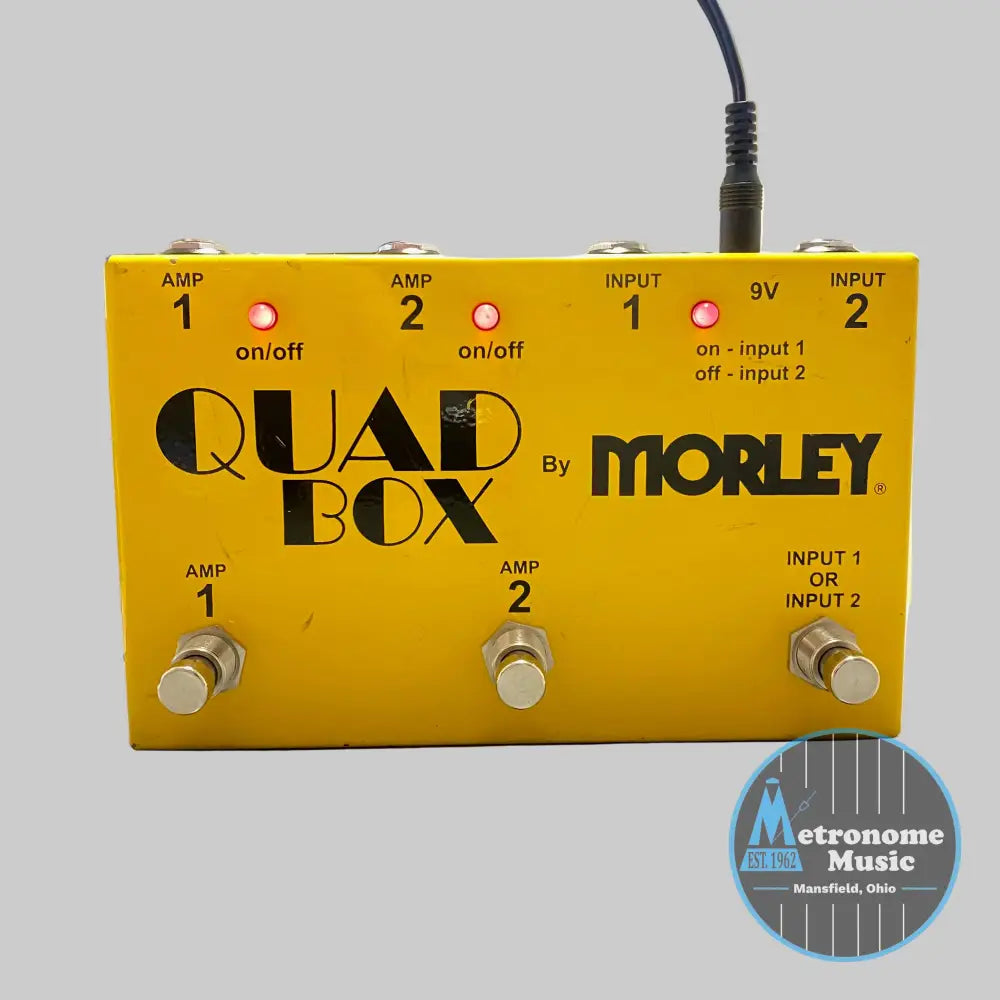 Yellow Quad Box by Morley guitar effects pedal on a desk