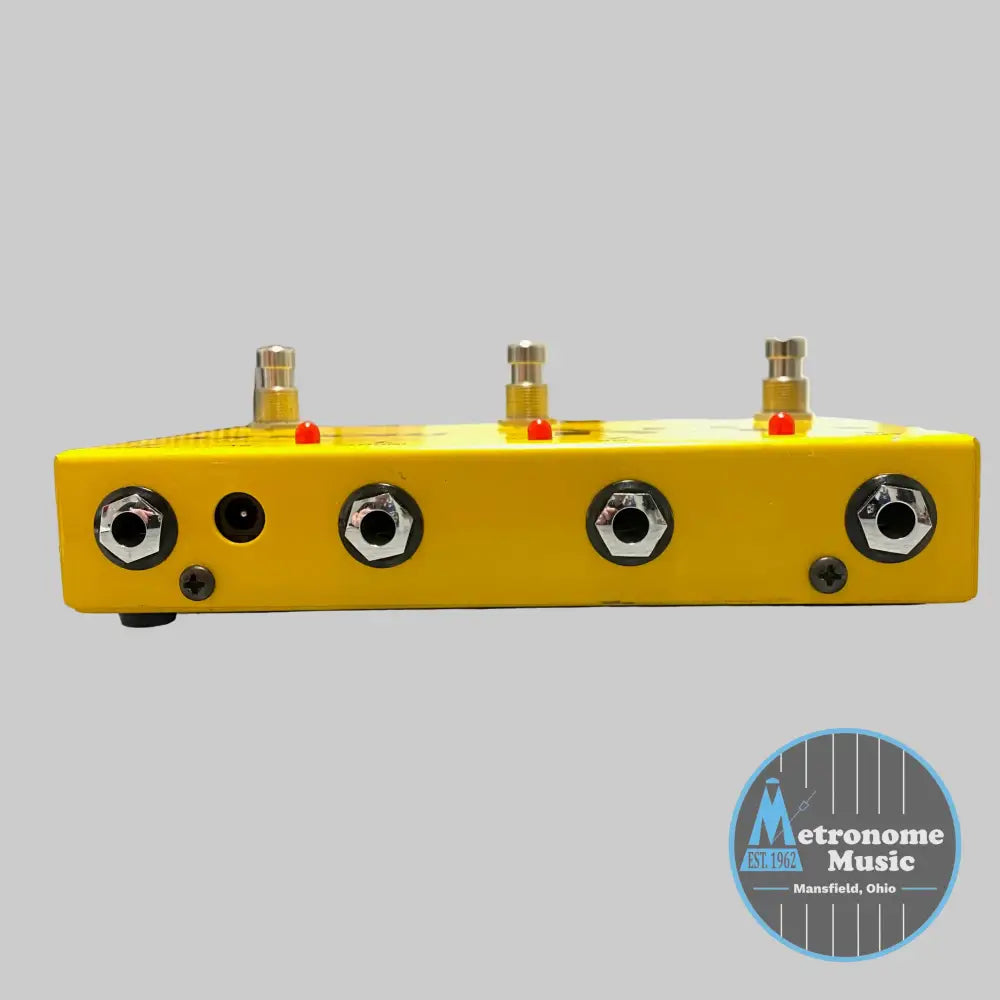 Yellow electronic device with multiple ports on a desk